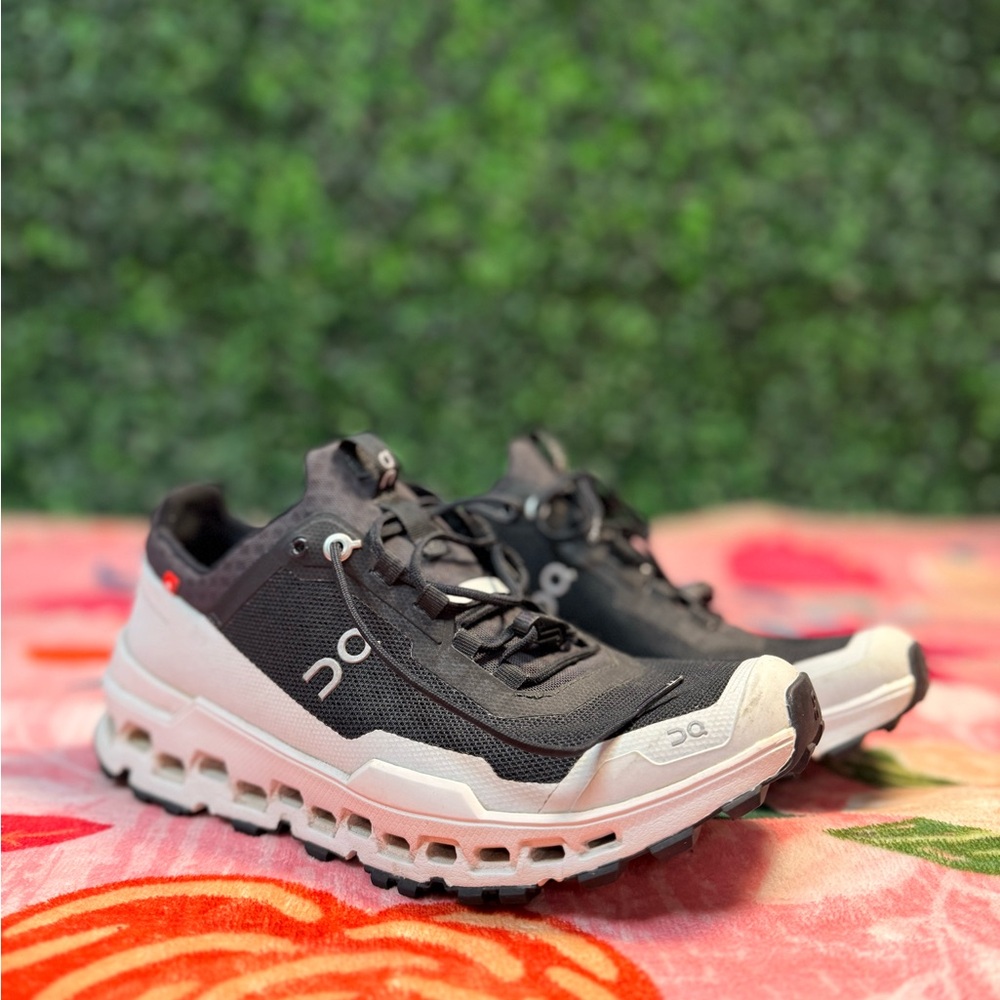 On Running Black and White Athletic Shoes with Red Accents